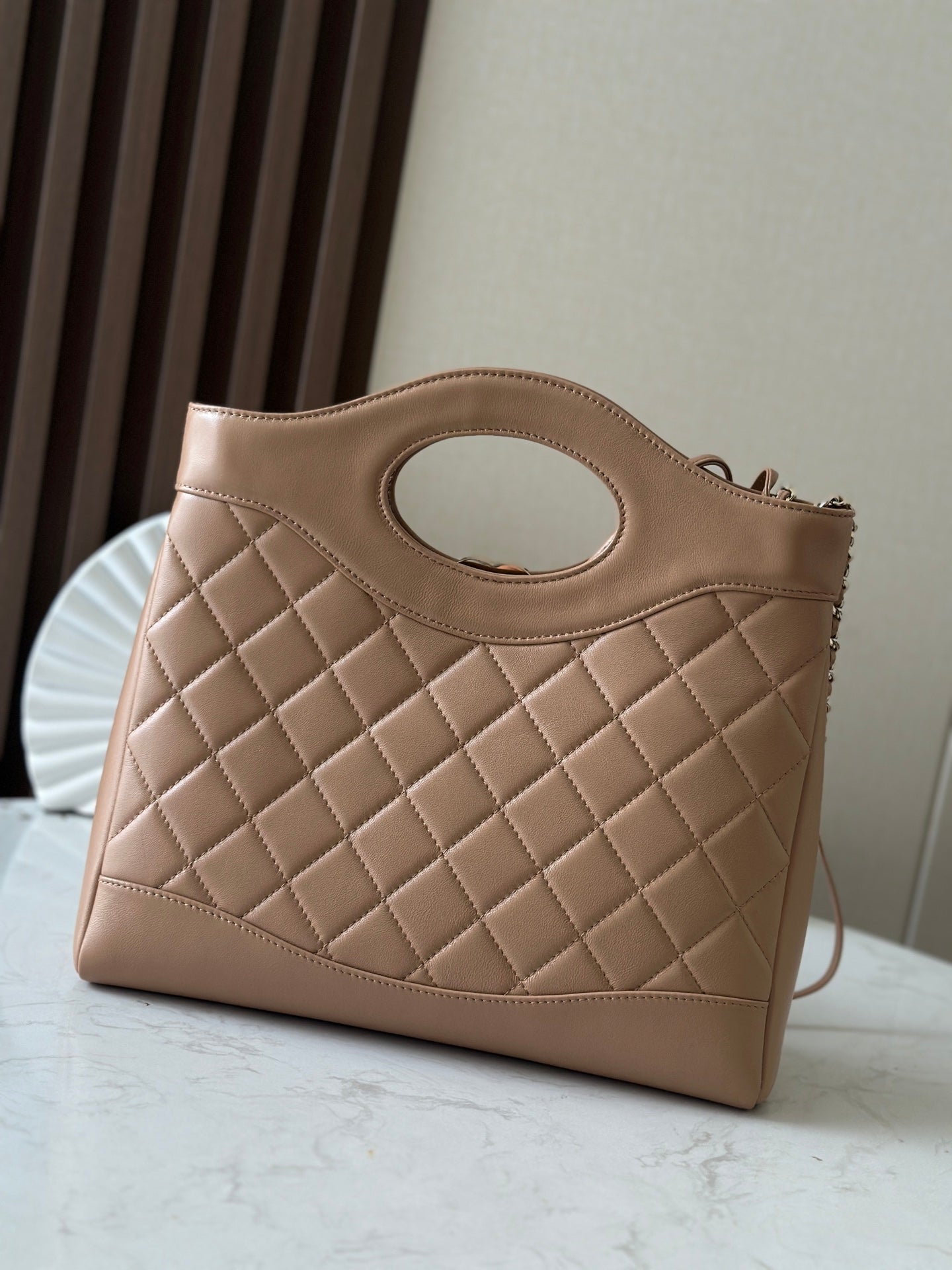 Chanel quilted leather tote bag with oval cutout and CC logo, top handle