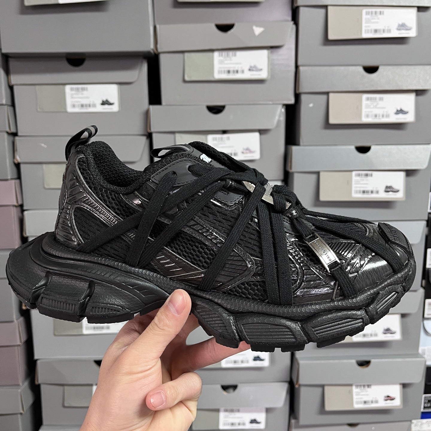 Black Balenciaga unisex sneakers with mesh and textured leather panels, lace-up front