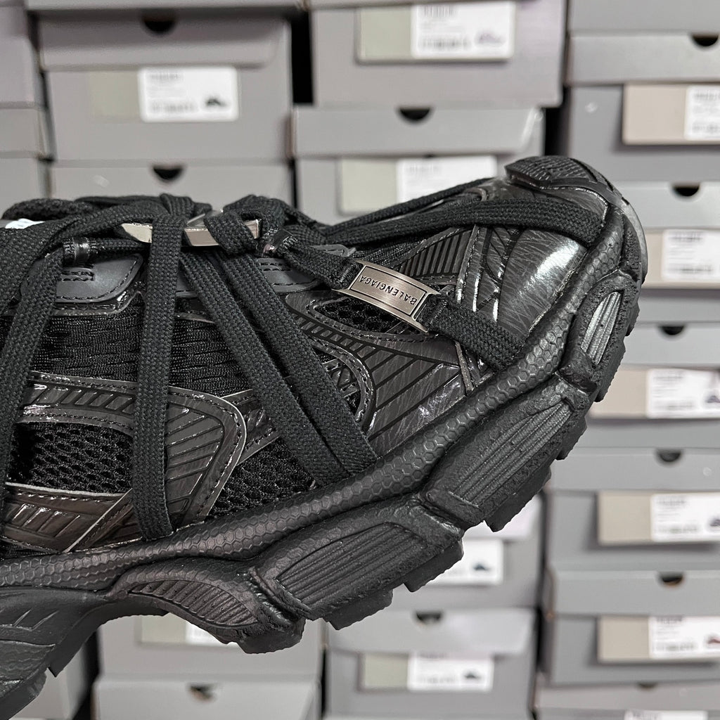Black Balenciaga unisex sneaker side view with webbed straps and embossed details