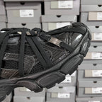 Black Balenciaga unisex sneaker side view with webbed straps and embossed details