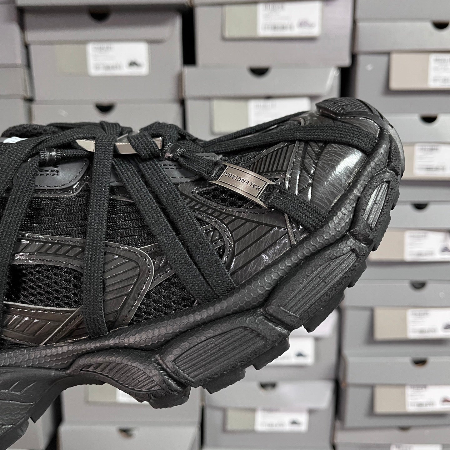 Black Balenciaga unisex sneaker side view with webbed straps and embossed details