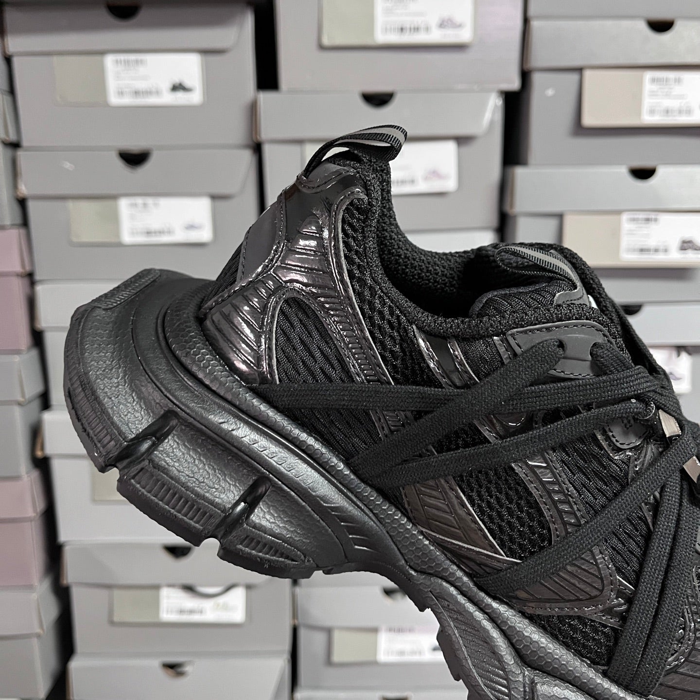 Black Balenciaga unisex sneaker quarter view with textured overlays and lace-up