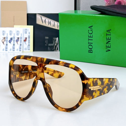 Tortoise sunglasses with light lenses and gold-tone bar on the side