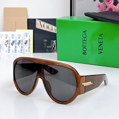 Brown sunglasses with dark gray lenses and gold-tone bridge detail