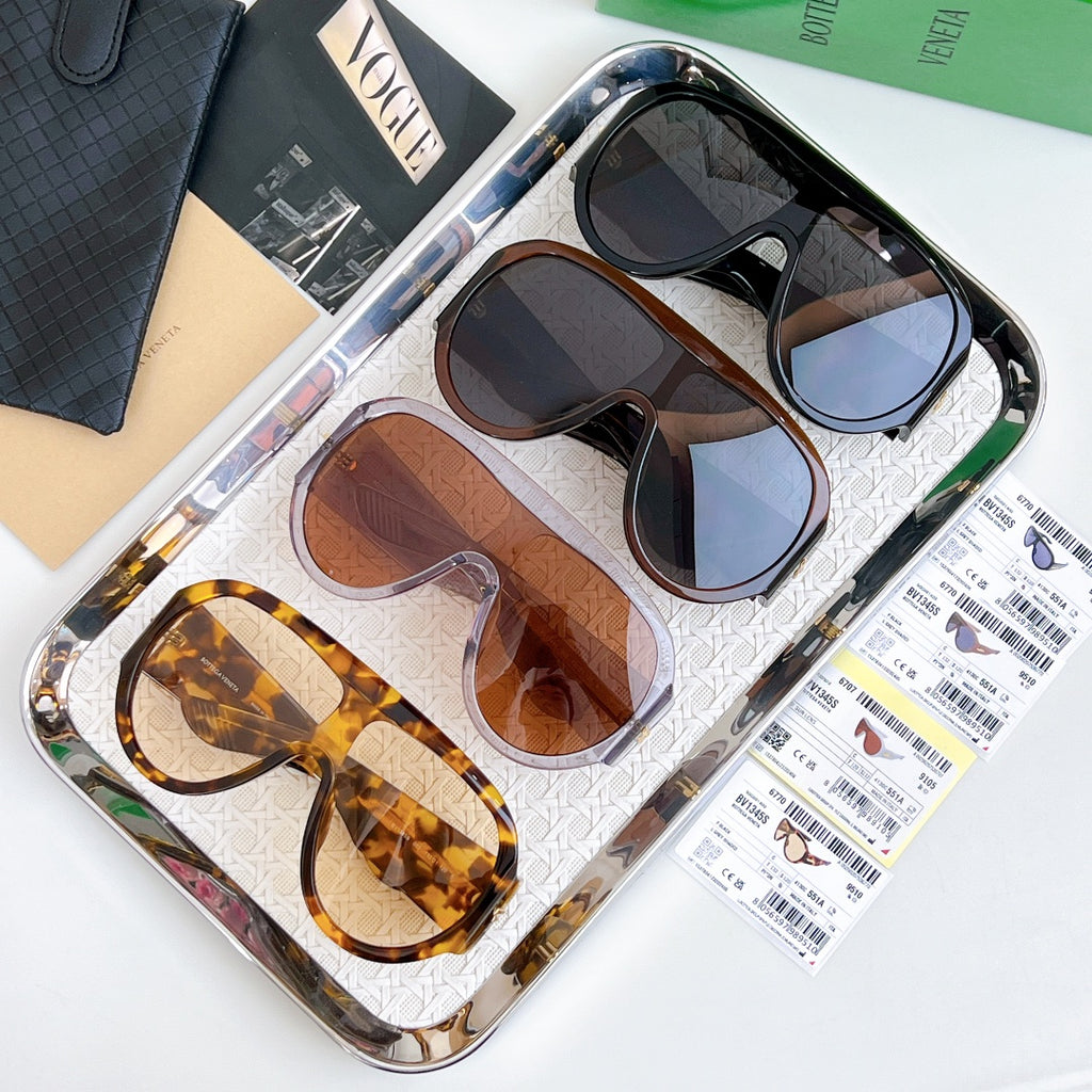 Multiple sunglasses on tray with mixed frames and tinted lenses