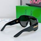 Black sunglasses with dark lenses and gold-tone side bar on temples