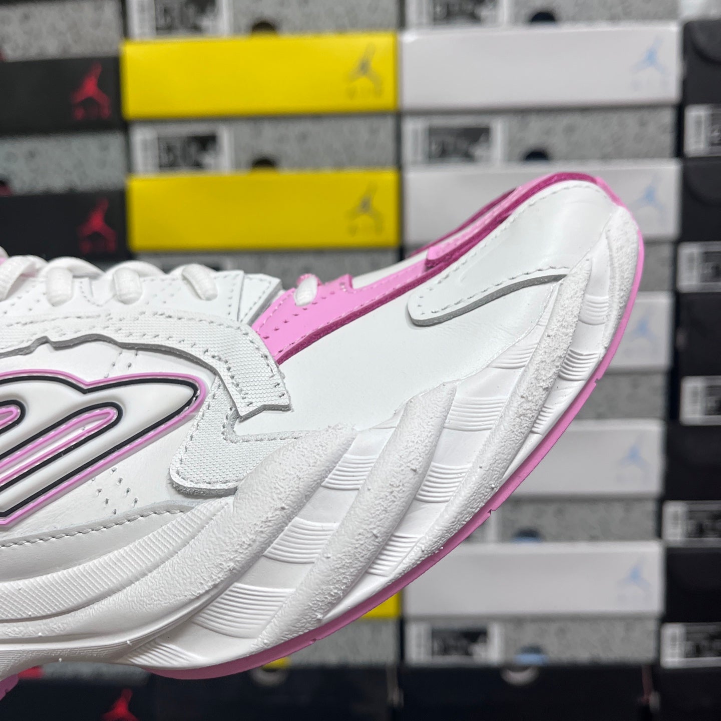 White and pink Balenciaga sneaker angled side view with pink trim and chunky sole