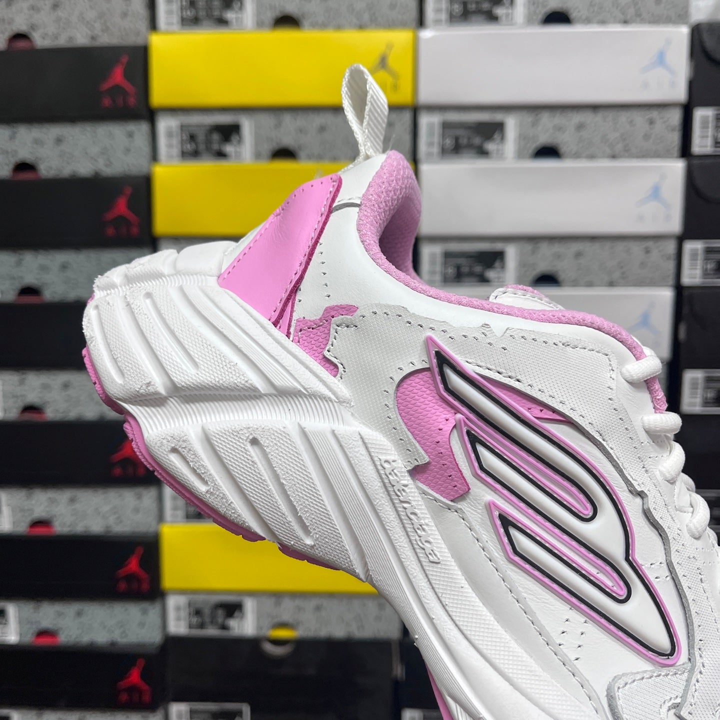 White and pink Balenciaga sneaker with pink heel panel and laces, side emblem visible