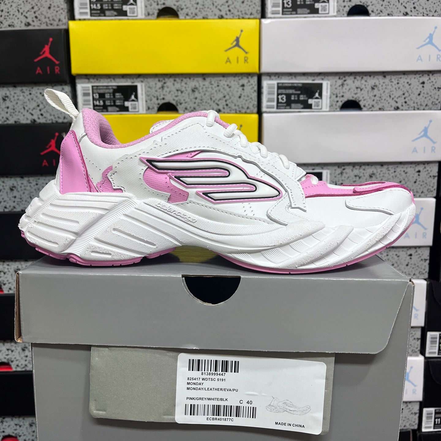 White and pink Balenciaga sneaker side view with oversized side emblem and lace-up