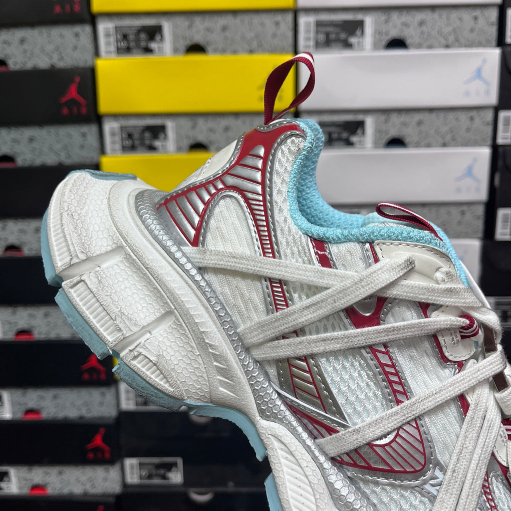 Balenciaga low-top sneaker with white upper, red trim, and light blue inner lining