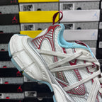 Balenciaga low-top sneaker with white upper, red trim, and light blue inner lining