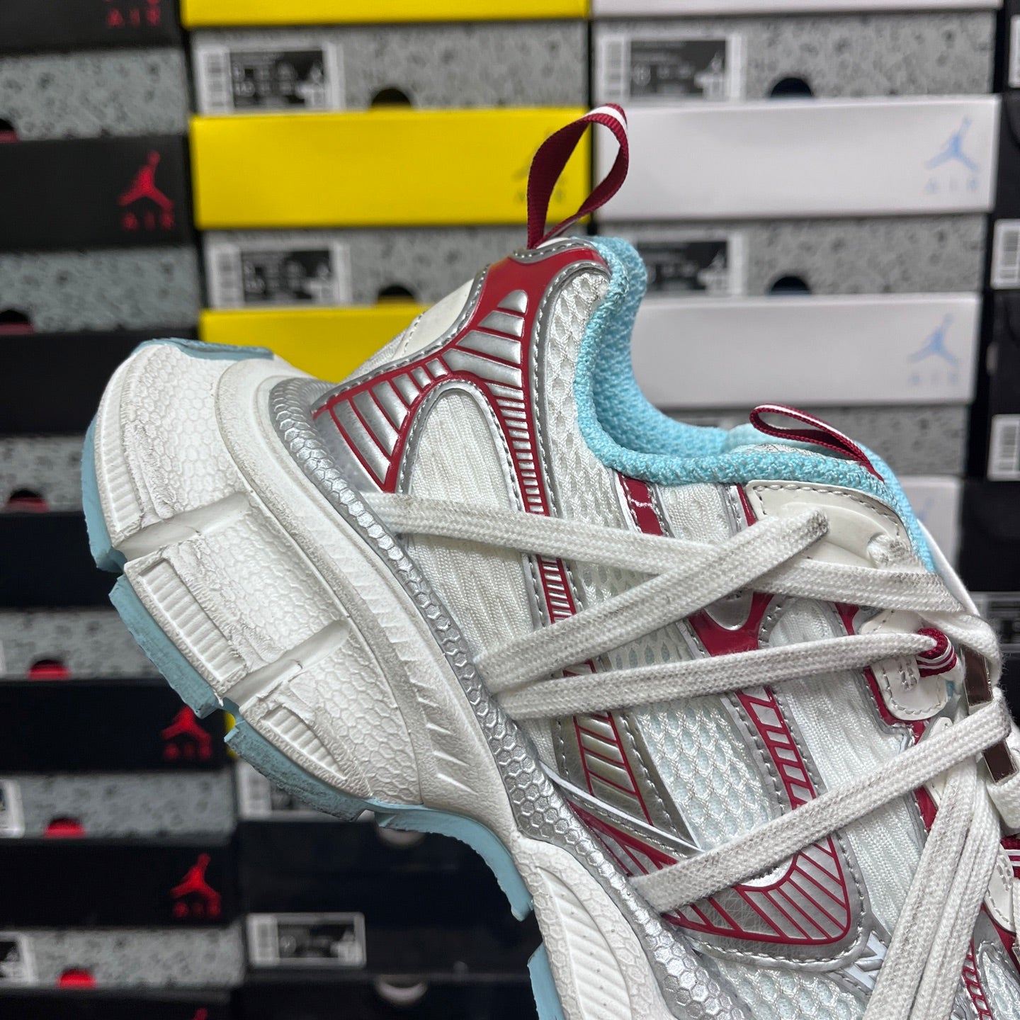 Balenciaga low-top sneaker with white upper, red trim, and light blue inner lining
