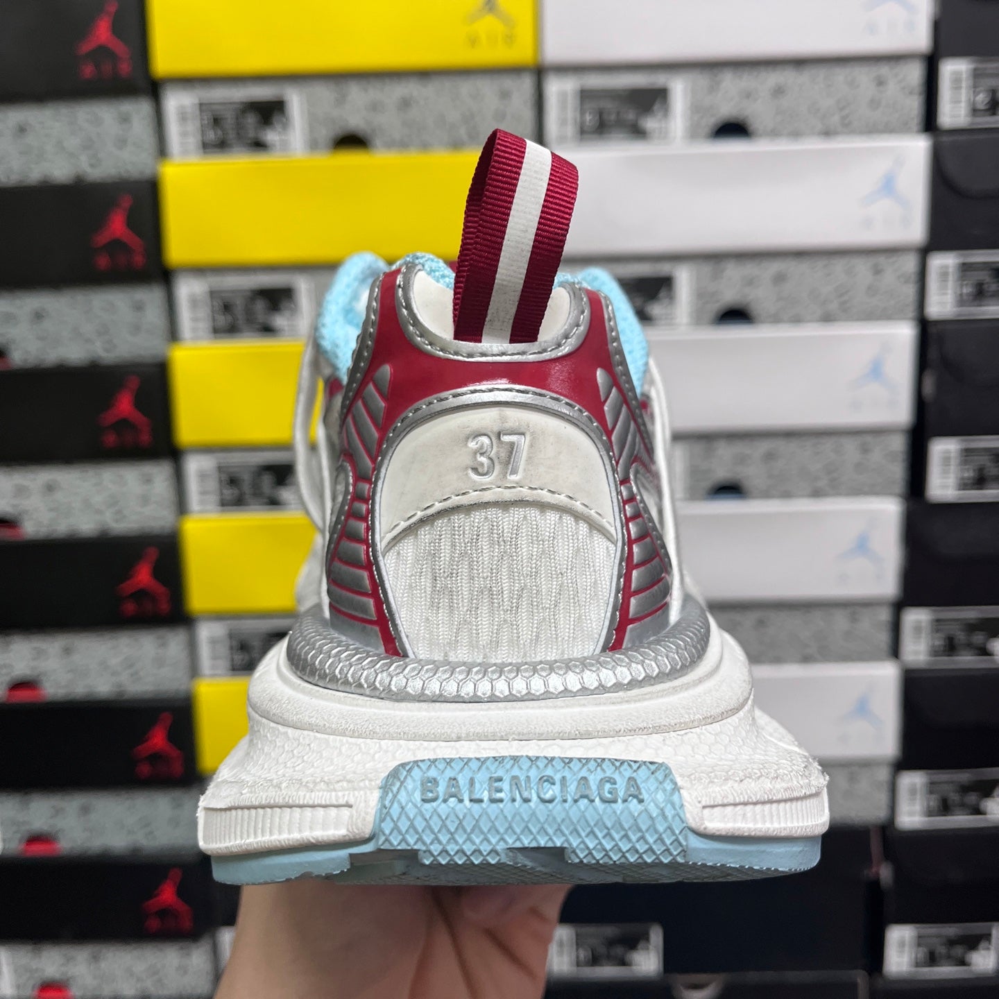Balenciaga sneaker heel with white upper, red stripes, and light blue sole detail