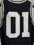 Black basketball jersey close-up with large white 01 number applique