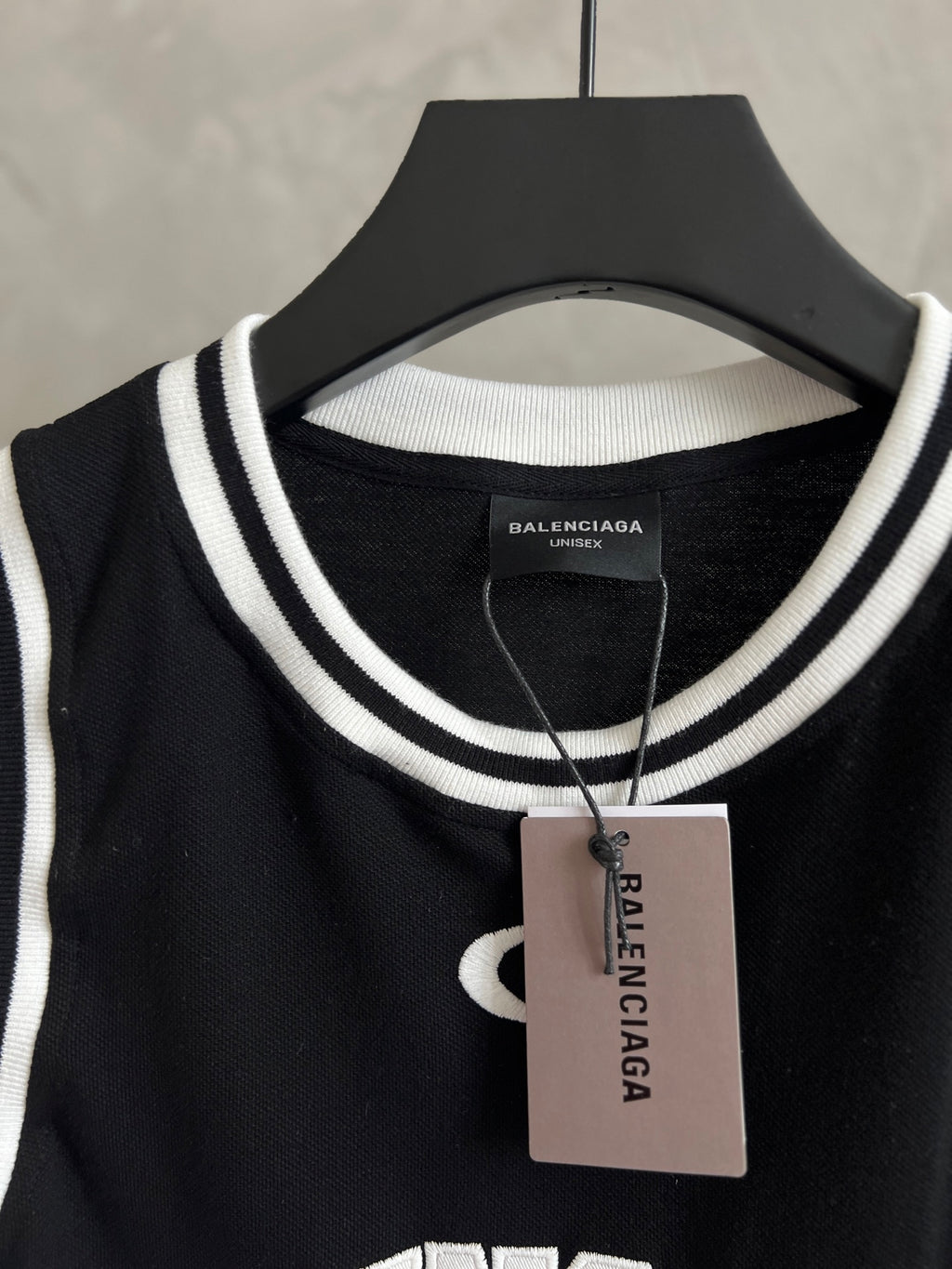 Black basketball jersey neckline with white rib trim and Balenciaga size tag