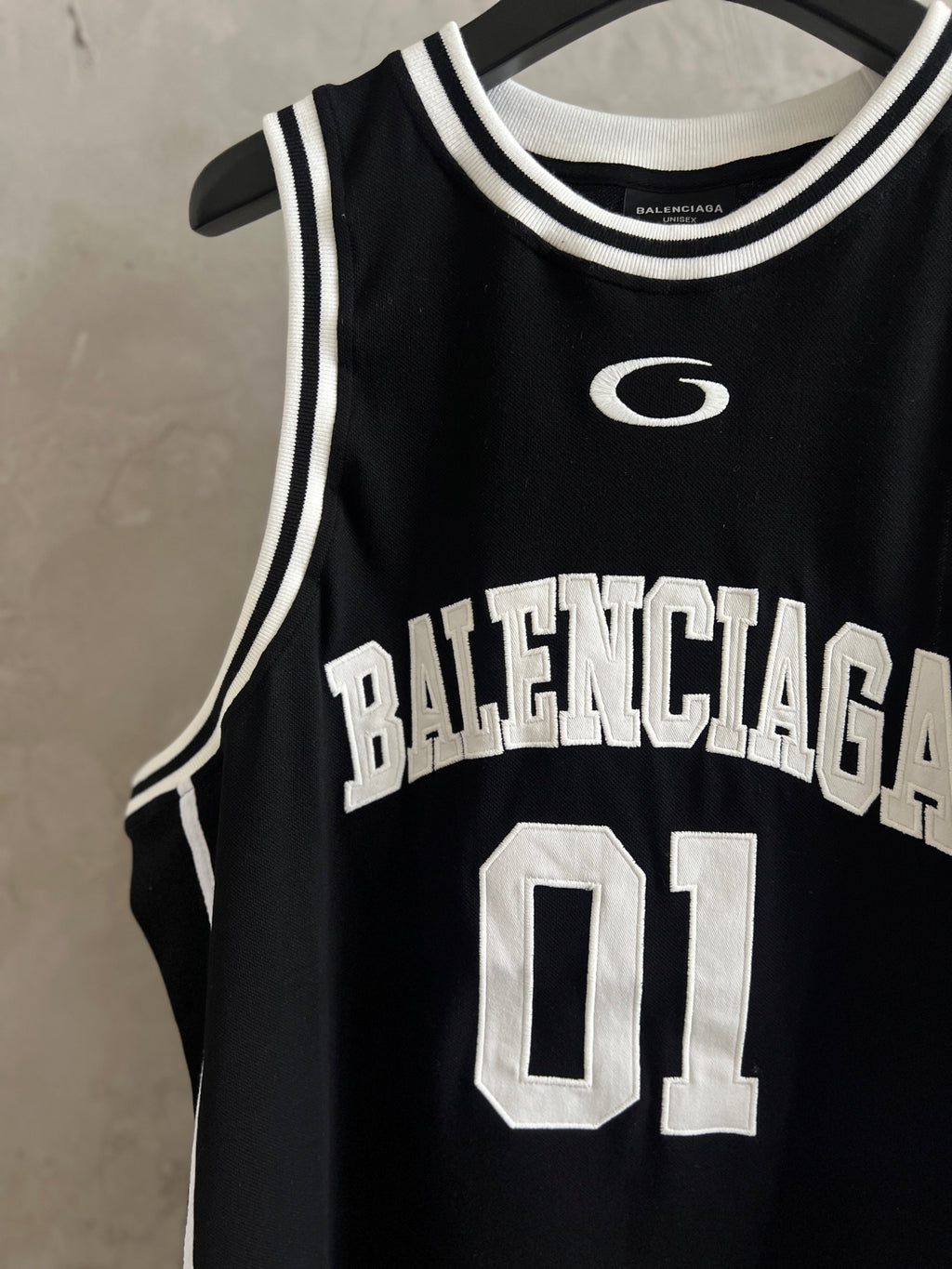 Black basketball jersey with white G logo, Balenciaga text, and 01 number