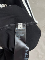 Black jersey fabric close-up with interior care label and tag