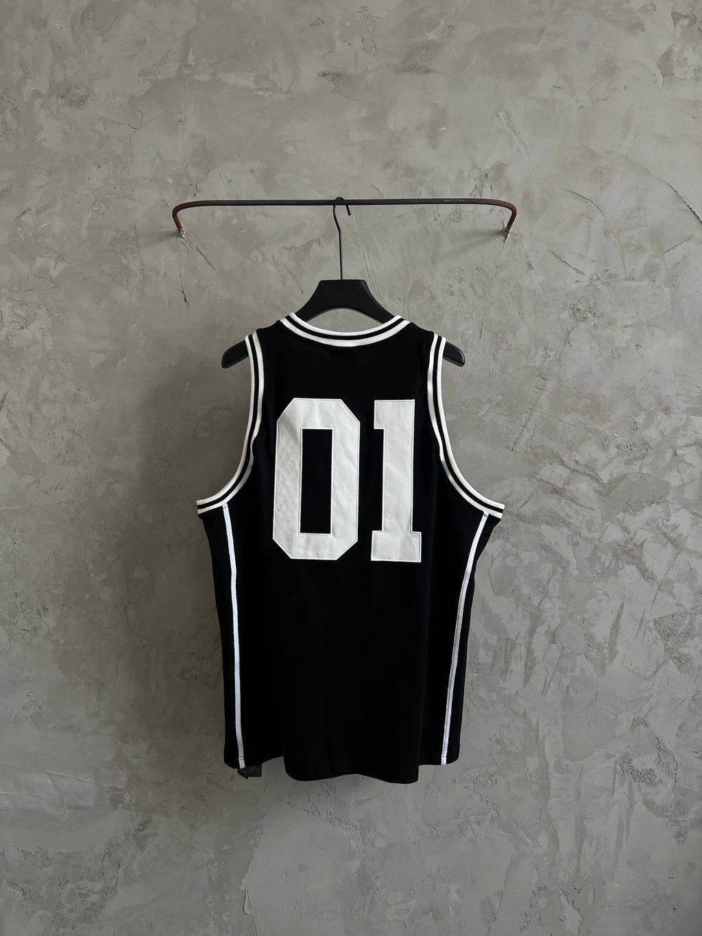 Black basketball jersey with white trim stripes and Balenciaga 01 back graphic