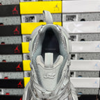 Unisex light gray sneakers with padded collar and heel tag, rear view