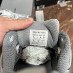 Unisex light gray sneaker tongue label with size markings, interior heel opening visible