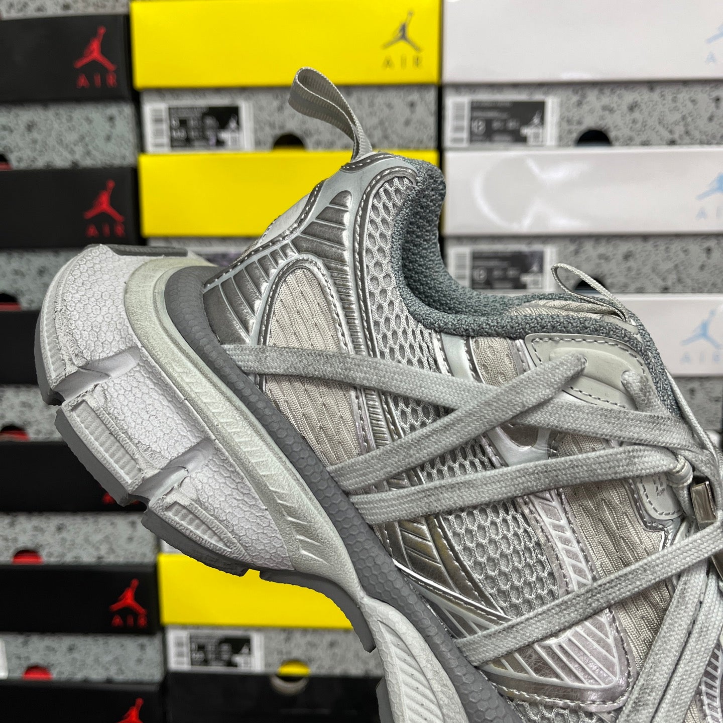 Unisex light gray sneakers, heel and side view with textured overlays and laces