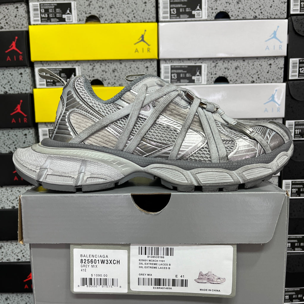 Unisex light gray lace-up sneakers with mesh and panel detailing, on shoe box