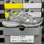 Unisex light gray lace-up sneakers with mesh and panel detailing, on shoe box