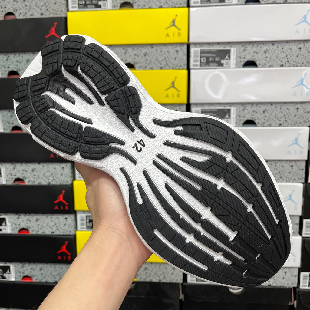 Black-and-white sneaker outsole with tread pattern and traction grooves