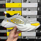 White and yellow unisex sneakers with black collar and oversized side logo