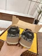 Fendi sneakers heel view, black/white logo knit with FENDI label, beige sole.