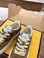 Fendi unisex sneakers close-up with Fendi logo on tongue, brown pattern and white laces
