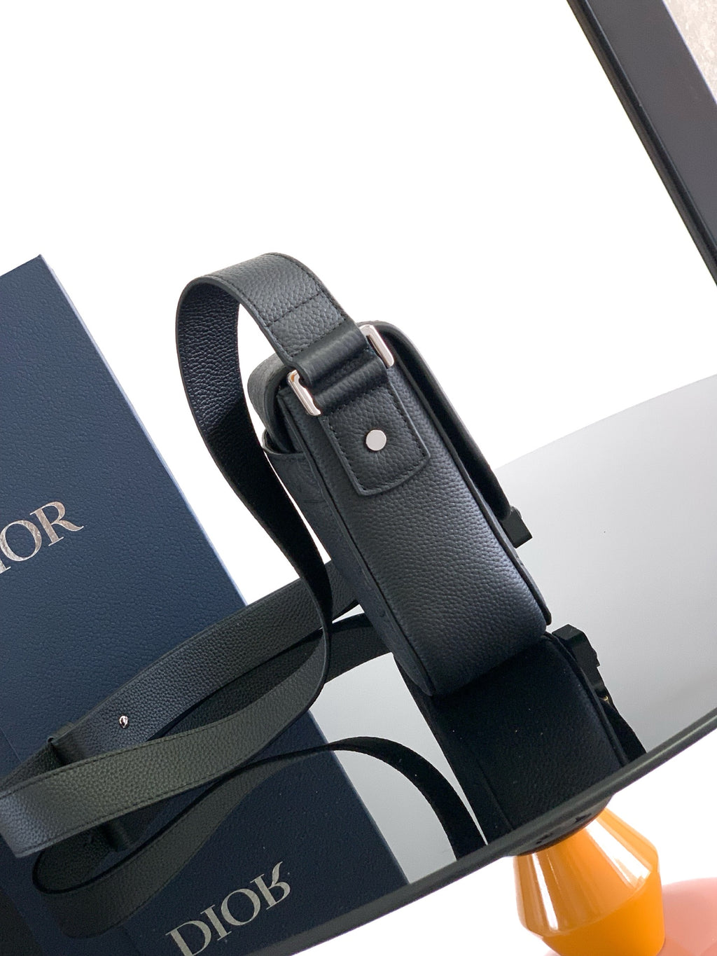 Dior crossbody strap in dark leather with adjustable buckle and metal hardware