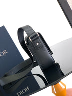 Dior crossbody strap in dark leather with adjustable buckle and metal hardware