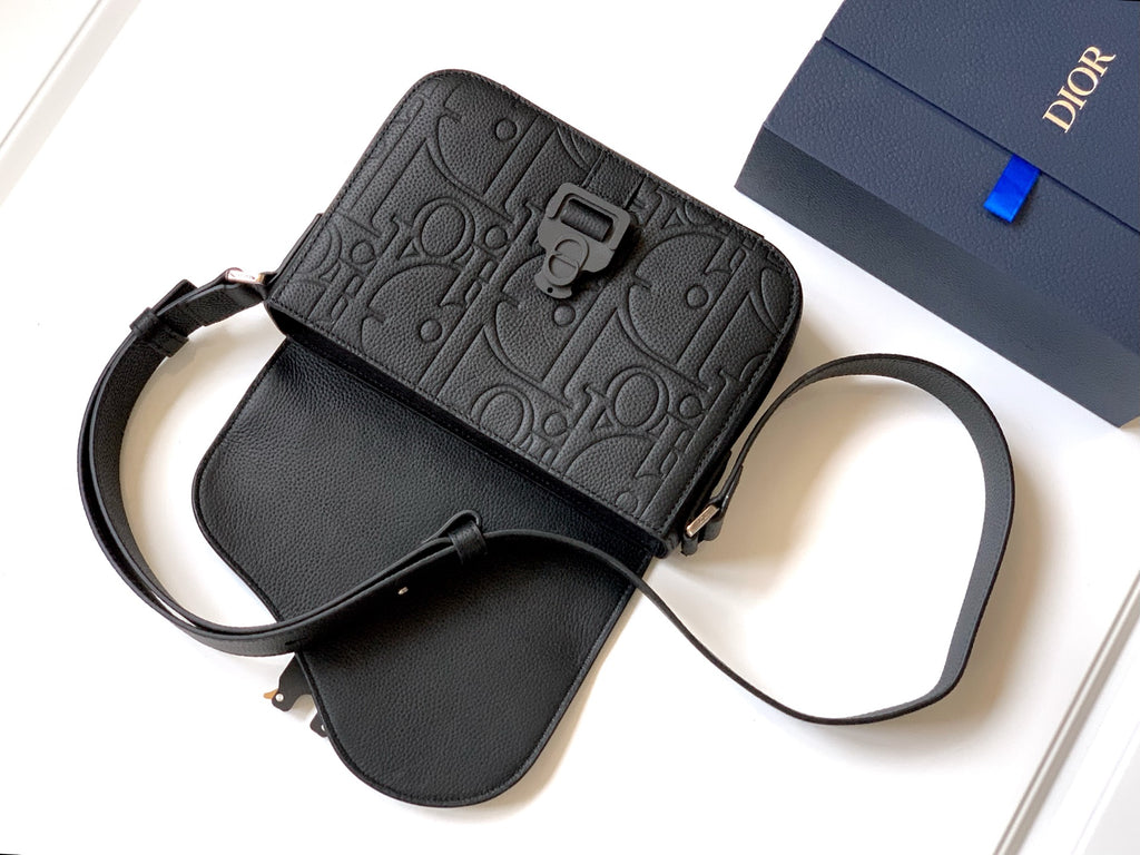 Dior mini crossbody bag in black leather with embossed logo panel and shoulder strap