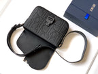 Dior mini crossbody bag in black leather with embossed logo panel and shoulder strap