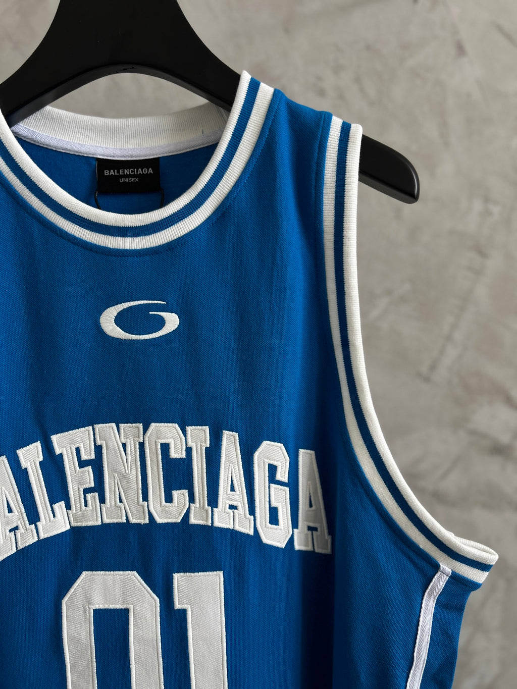 Balenciaga blue tank top with circular logo and white “BALENCIAGA” text