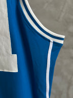 Blue sleeveless jersey with white ribbed collar and double stripe trim