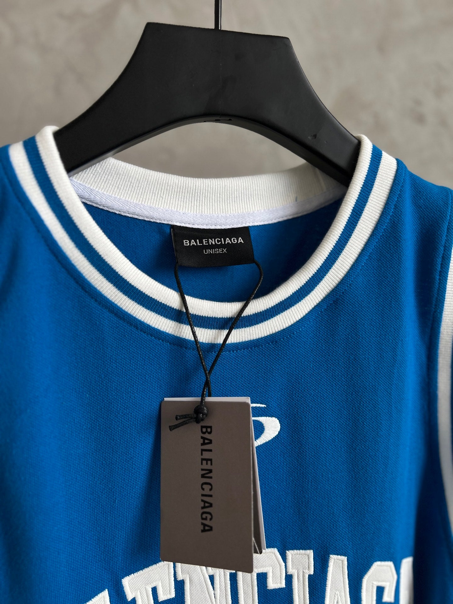 Blue sleeveless jersey neckline with Balenciaga inner label and hang tag
