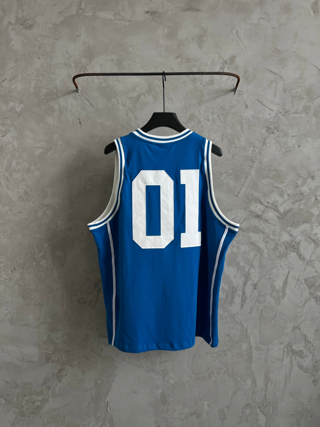 Balenciaga blue sleeveless jersey on hanger with white “01” graphic