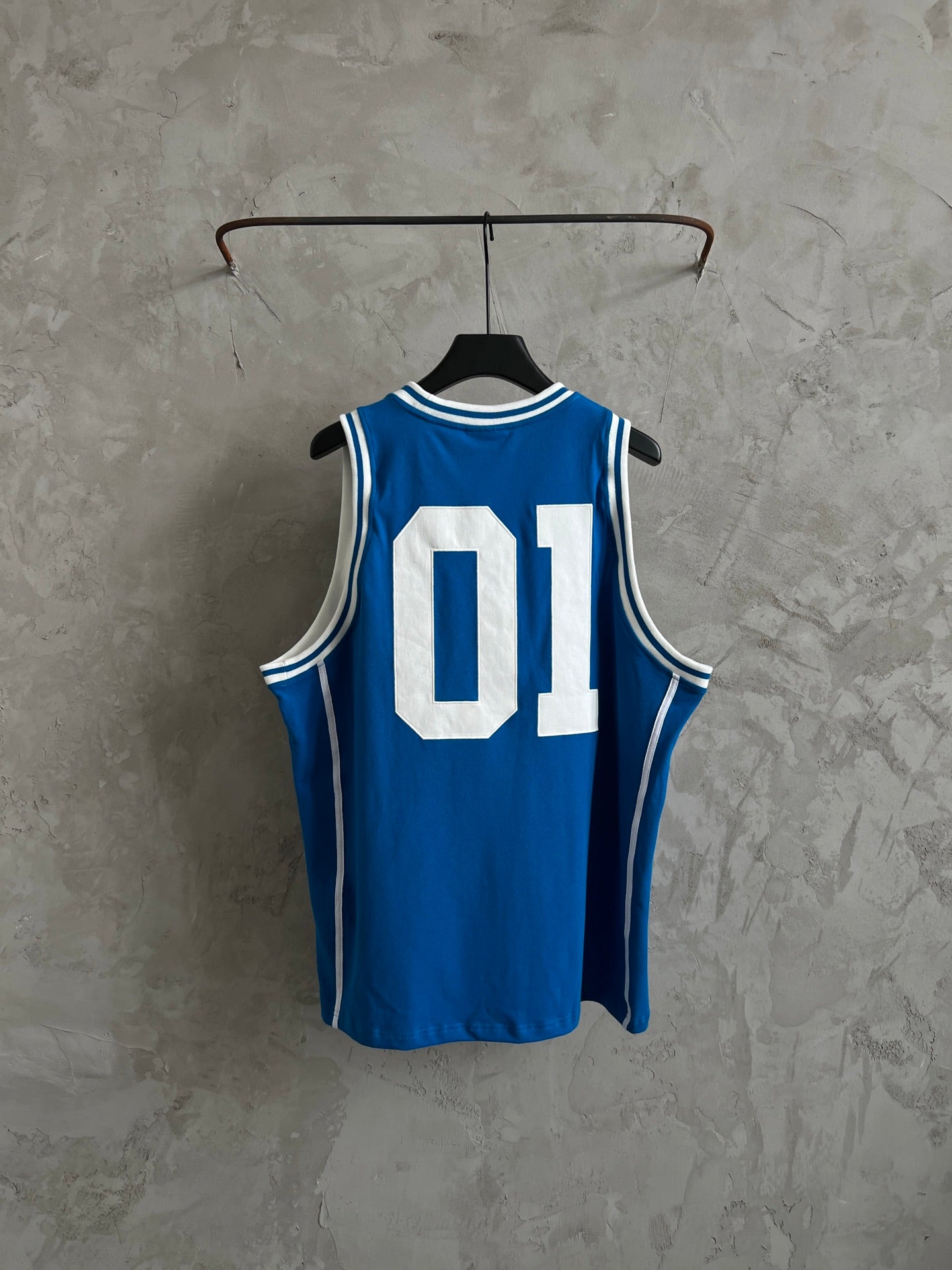 Balenciaga blue sleeveless jersey on hanger with white “01” graphic