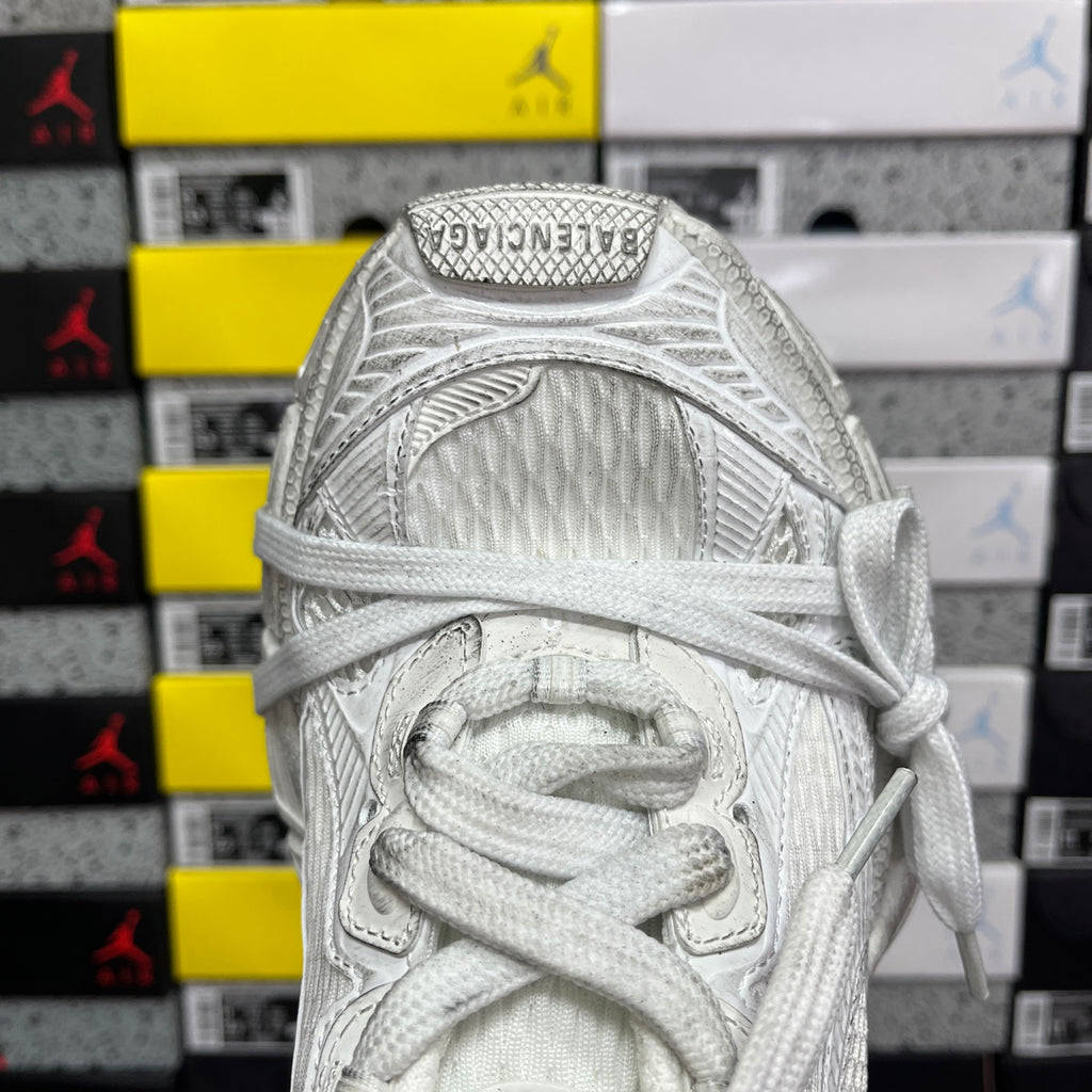 Balenciaga unisex sneaker close-up at tongue with white laces and textured upper