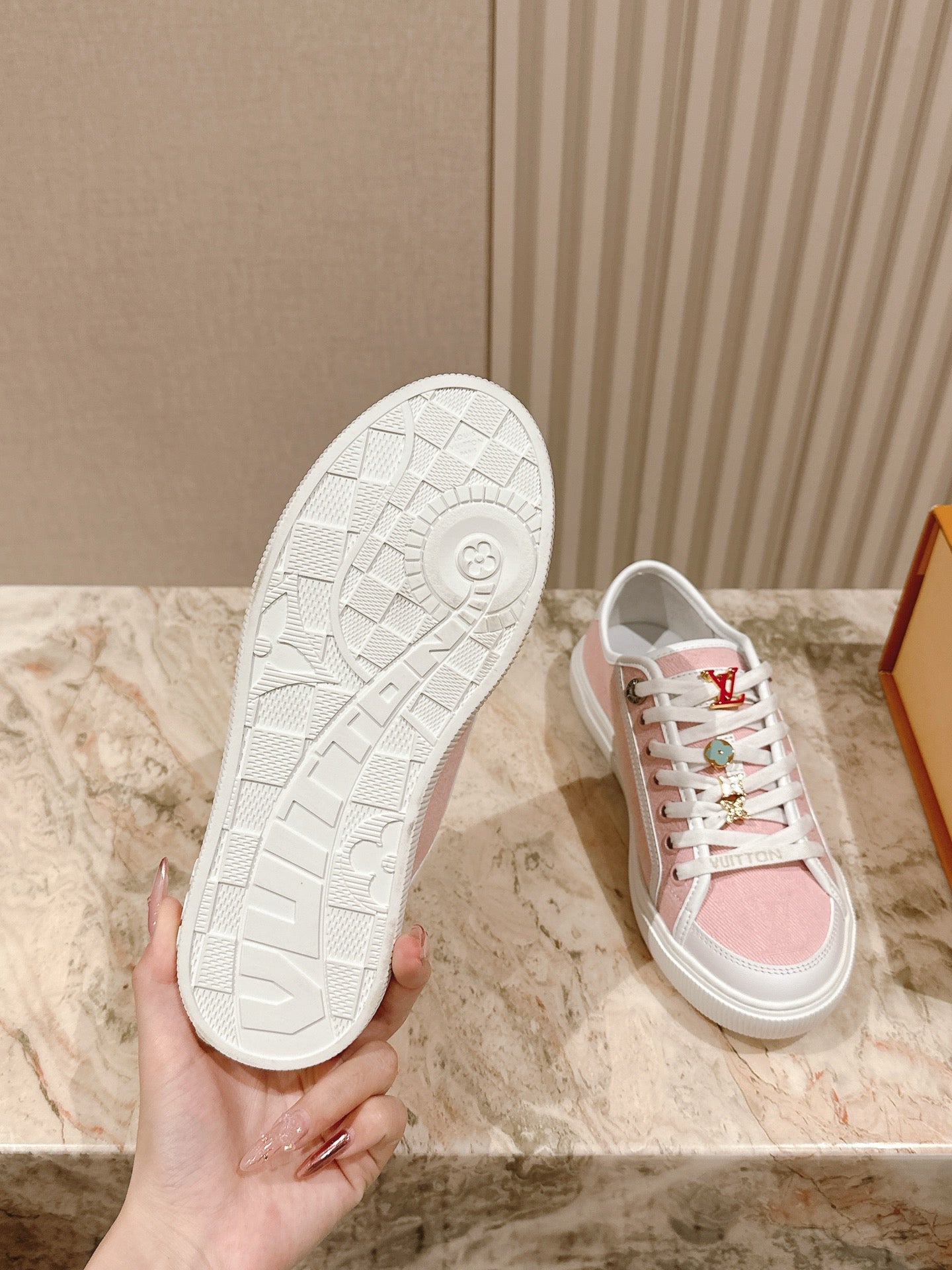 White rubber outsole of a pink-and-white low-top sneaker