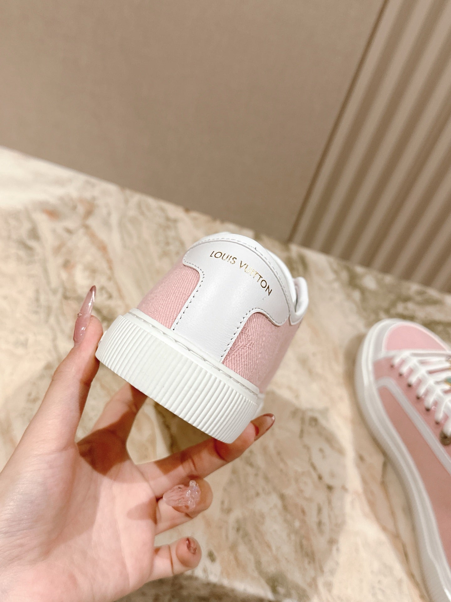 Pink-and-white sneaker sole with Louis Vuitton logo on heel