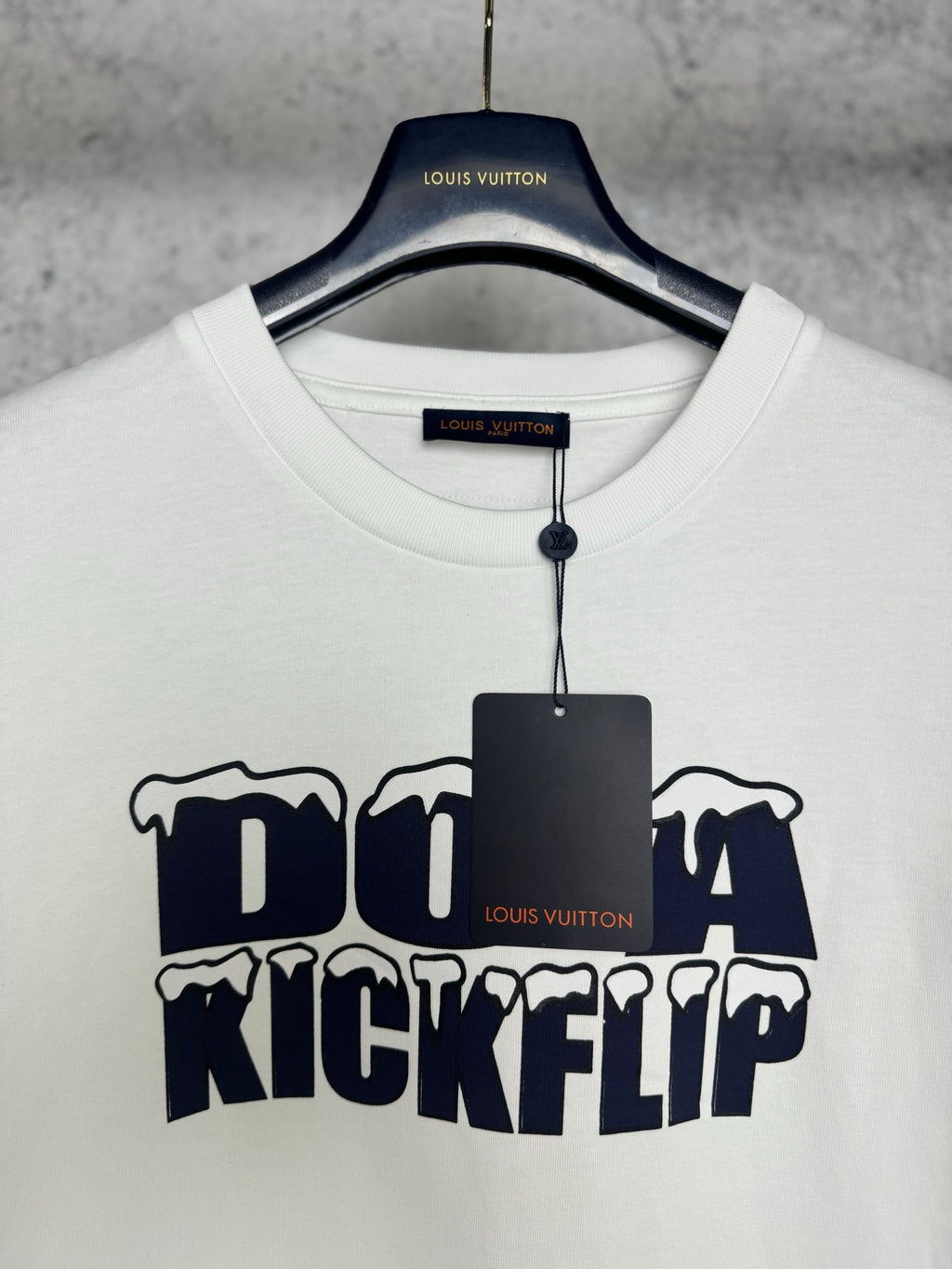 White T-shirt with crew neck and Louis Vuitton tag, featuring navy "DO A KICKFLIP" graphic