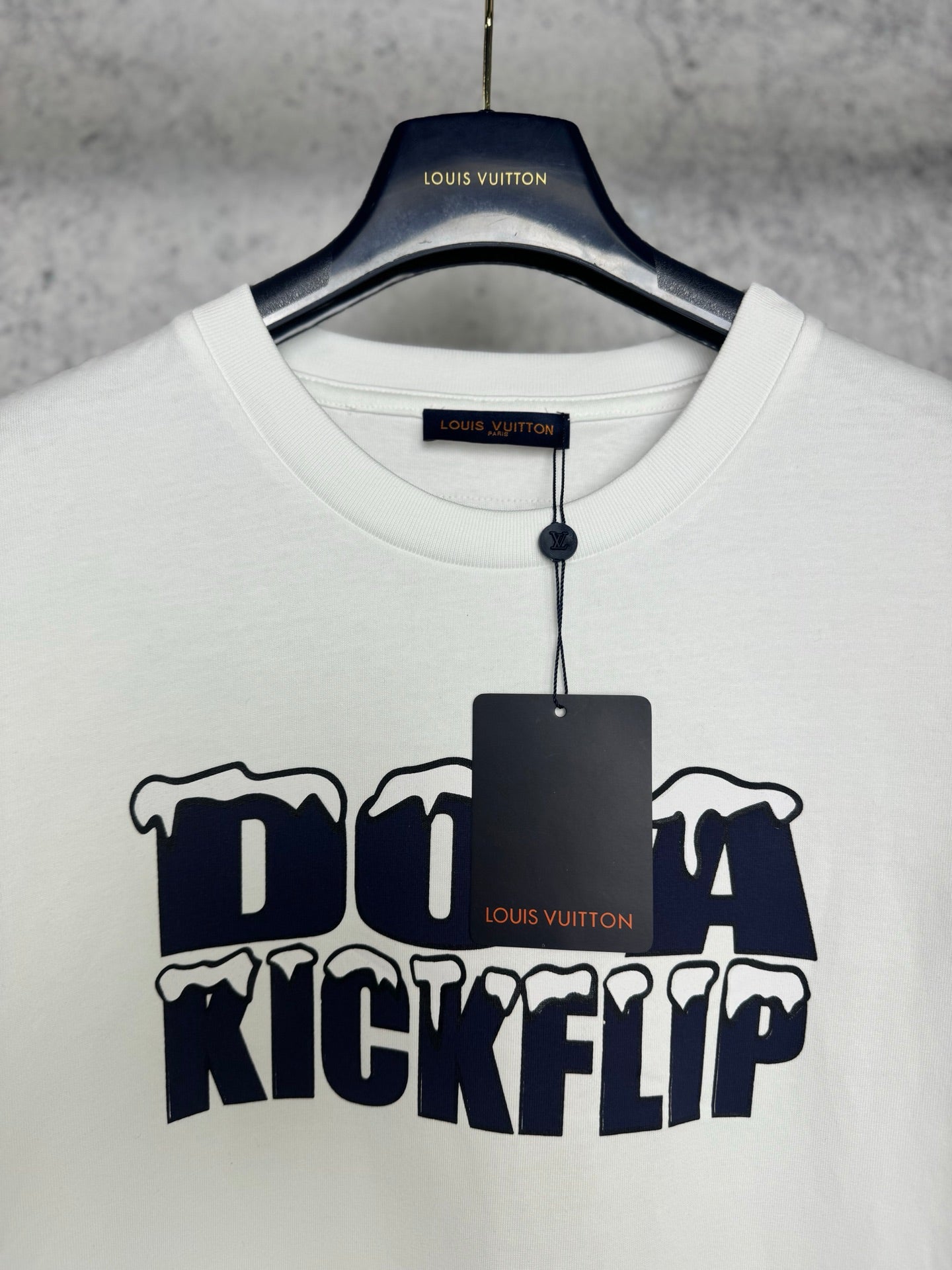 White T-shirt with crew neck and Louis Vuitton tag, featuring navy "DO A KICKFLIP" graphic