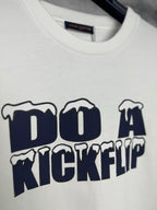 White T-shirt close-up of navy "DO A KICKFLIP" lettering