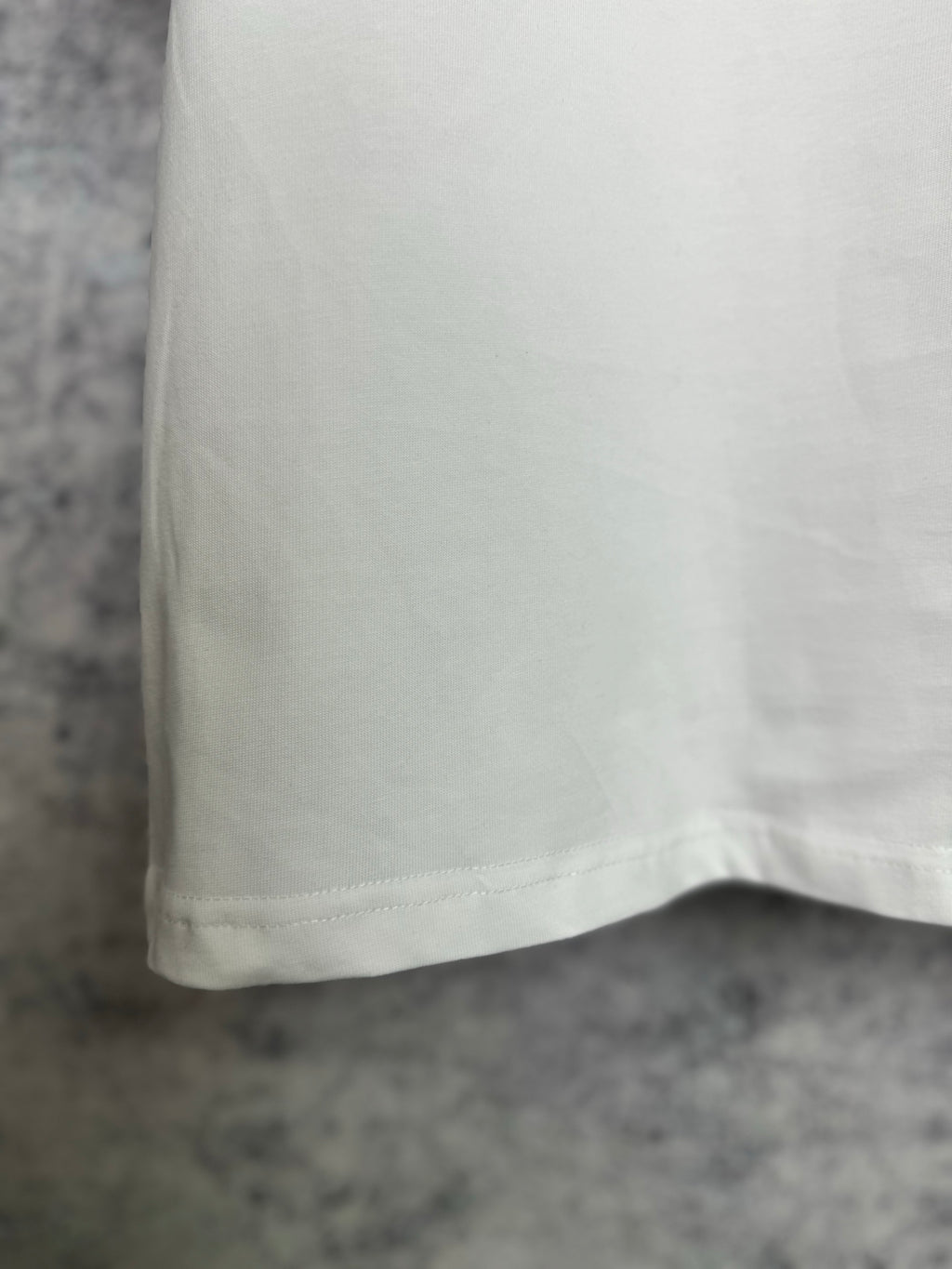 White T-shirt back view with curved hem and smooth fabric
