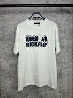 White T-shirt with navy "DO A KICKFLIP" graphic on the chest
