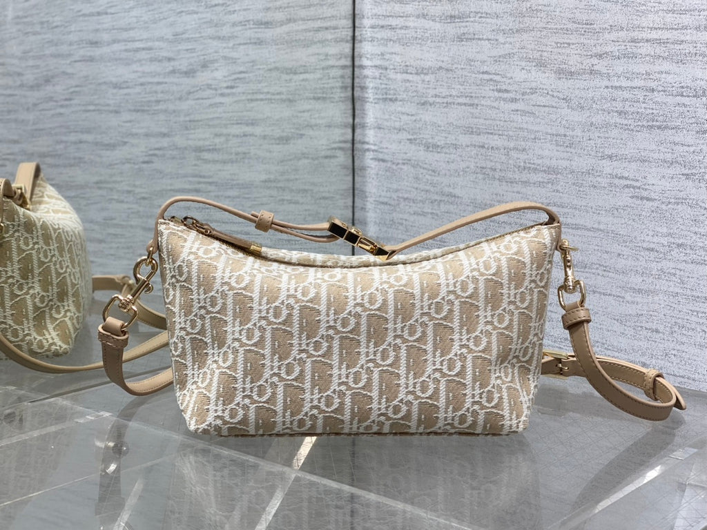 Dior monogram canvas shoulder bag with adjustable strap and zipper top, gold hardware