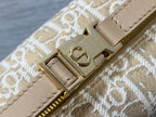 Dior monogram bag close-up: gold clasp on beige leather trim